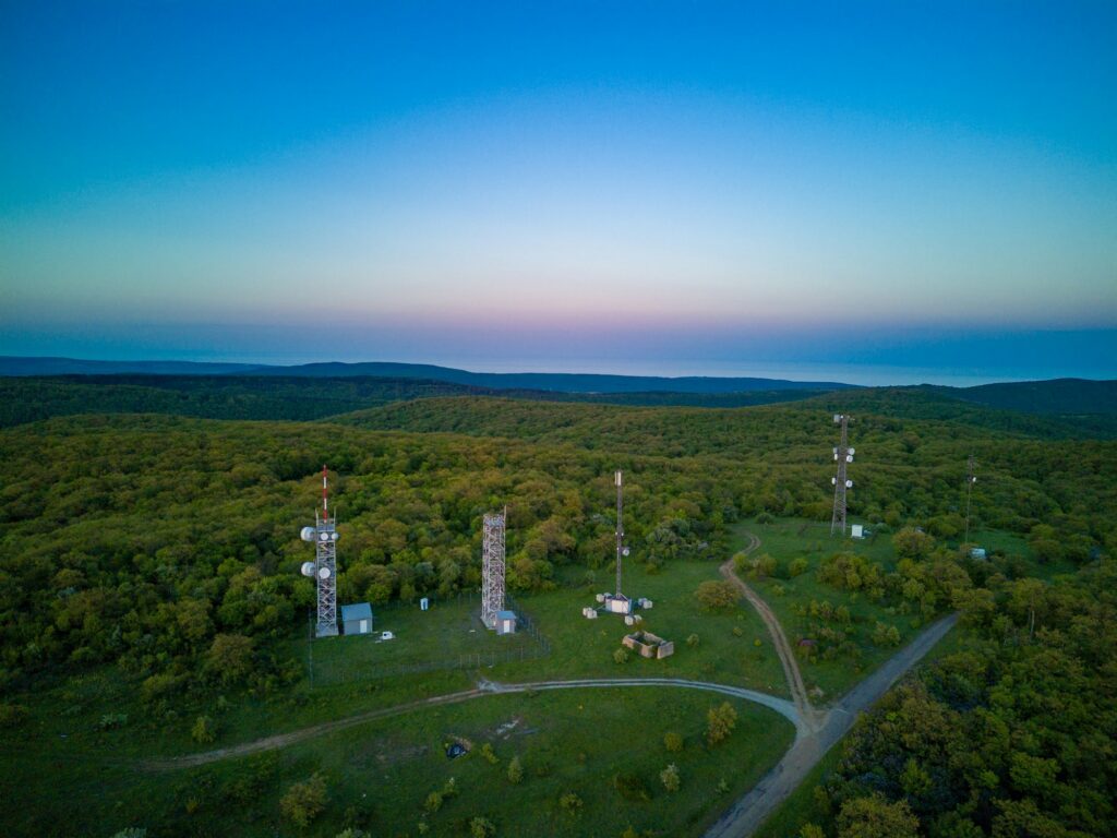 View of the hills covered with vegetation with cell towers against the backdrop