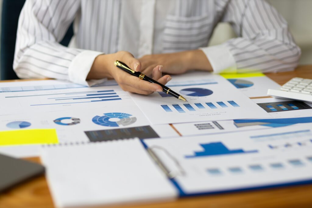 Professional investor or business finance accountant is analyzing market reports.