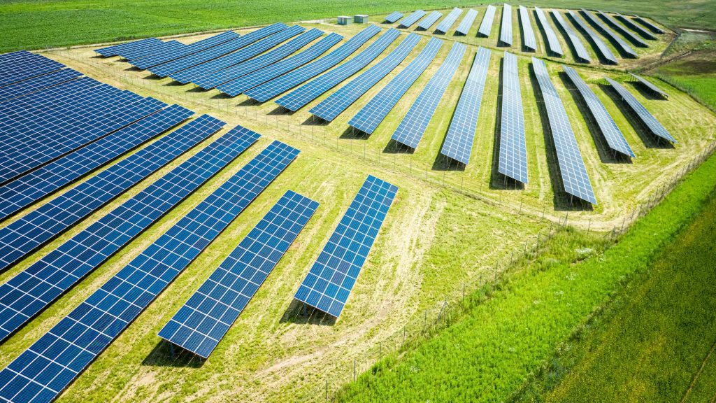 Solar Panels On Green Field. Photovoltaic Farm In Poland
