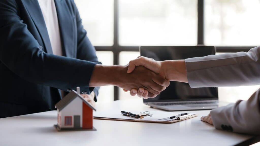 Real Estate Agent Shakes Hands With A Client